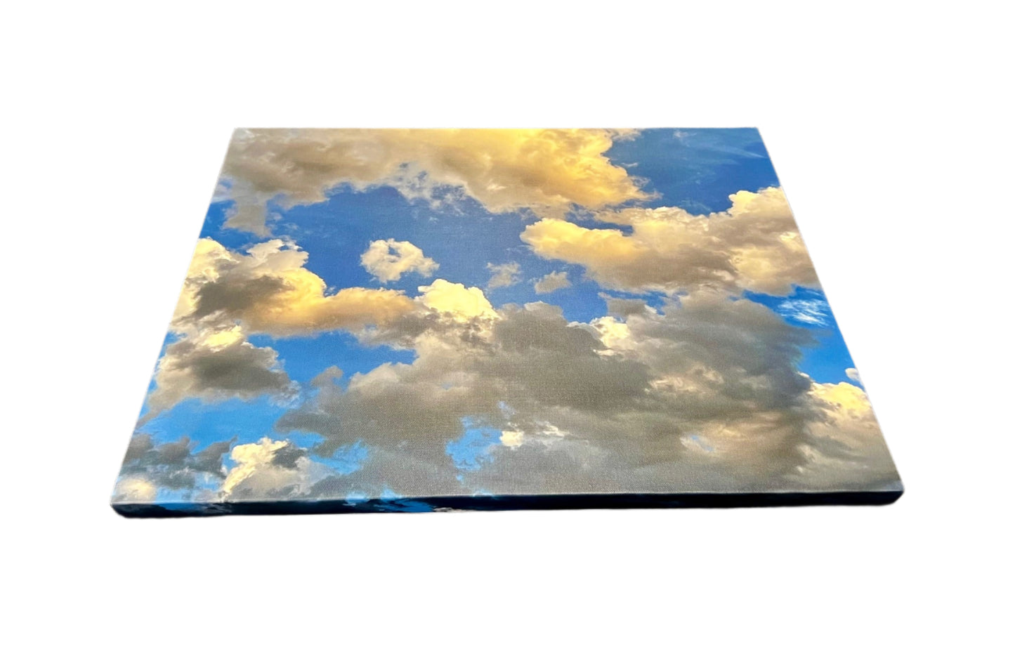 Canvas print of a blue sky with clouds on a textured surface